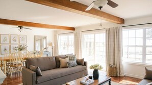 A cozy living room with a sofa, coffee table, and a dining area with a wooden table and chairs. - On one of the 𝗜𝘀𝗹𝗮𝗻𝗱'𝘀 𝗯𝗲𝘀𝘁 𝗯𝗲𝗮𝗰𝗵𝗲𝘀; enjoy sun, sand & sea! (Bedeque)