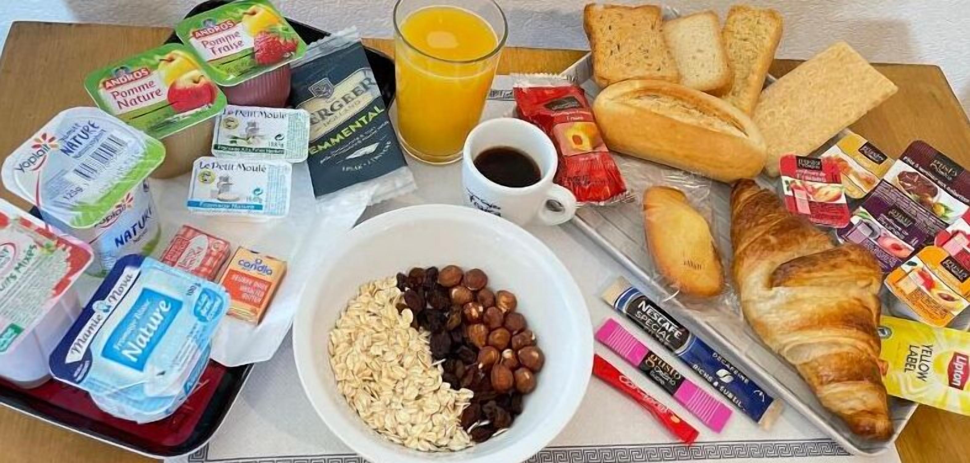 A breakfast tray with various food items and beverages.