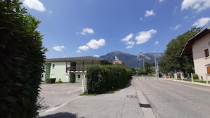A street view with a building that has a sign indicating it is a hotel. There are mountains in the background, and the sky is clear. - Fasthôtel Albertville (Albertville)