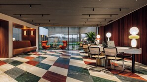 A modern hotel lobby with a checkered floor, seating area, and a view of the outdoors. - Altis Porto Hotel, member of Preferred Hotels & Resorts – L.V.X. (Porto)