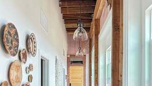 A hallway with wooden floors, a wooden ceiling, and a door at the end. - 3E Sunrise View (Honey Grove)