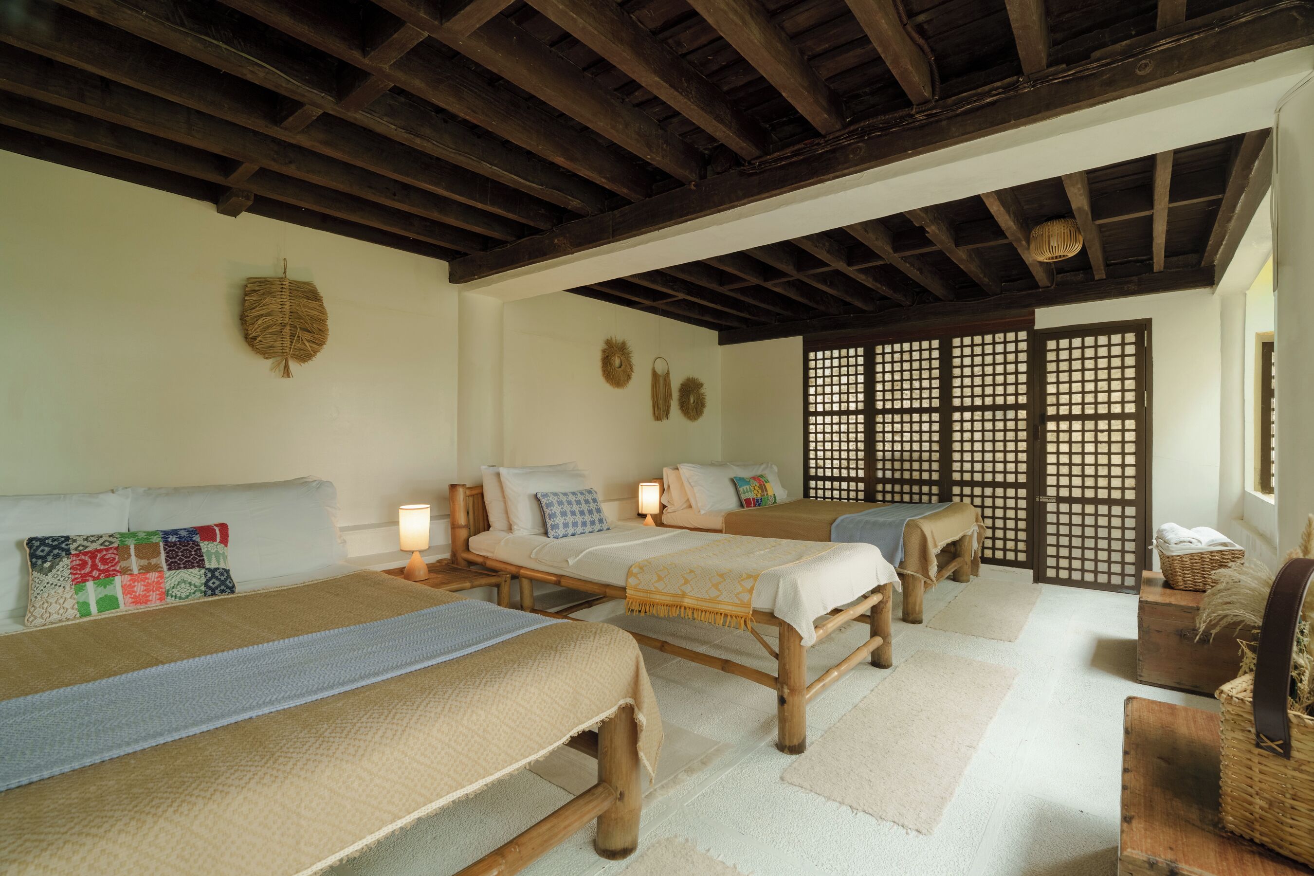 A traditional room with wooden beams, tatami mats, and shoji screens.