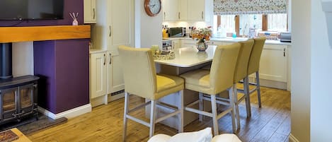 A compact living space with a kitchen, dining area, and a bed.