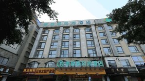 A multi-story hotel with a prominent sign at the entrance.