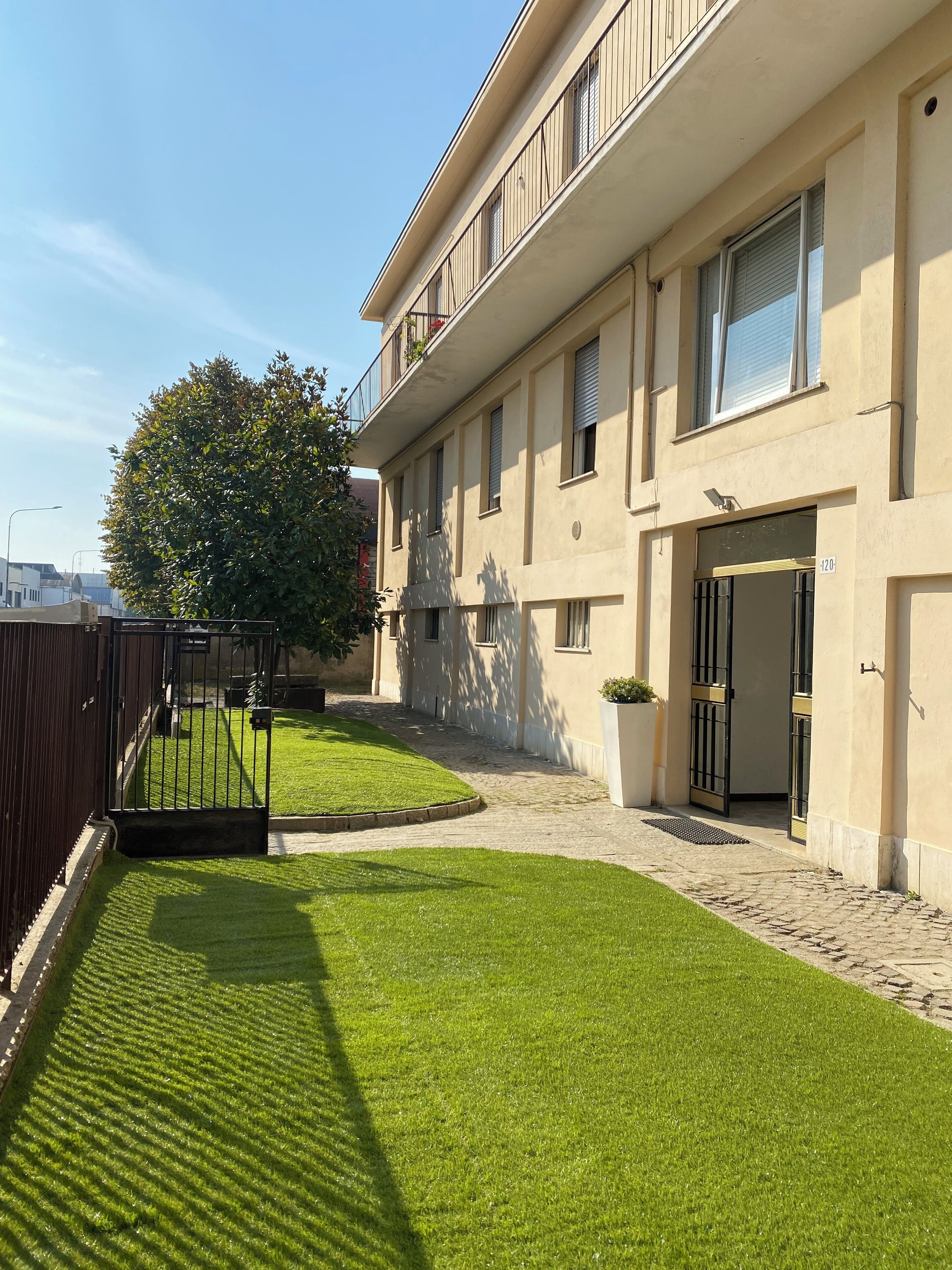 A building with a paved driveway and a well-maintained lawn.