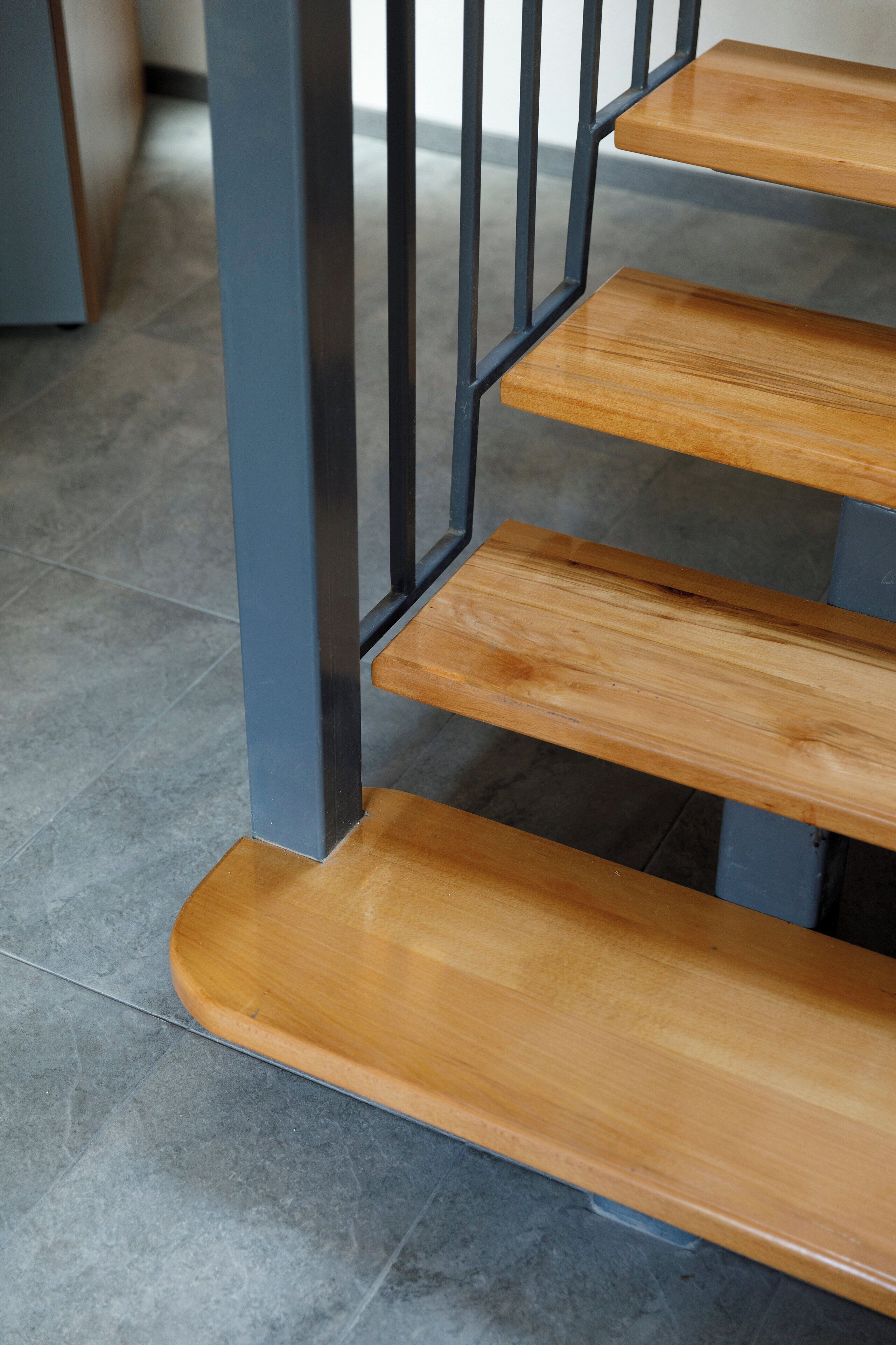 A staircase with wooden steps and metal railings.