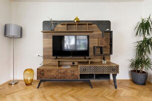 Aki Junior Apartment | Living area | 89-cm Smart TV with cable channels