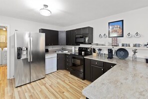 Enjoy cooking in this well-equipped kitchen with an oven, microwave, and coffee machine.