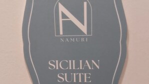 A sign with the text "NAMURI SICILIAN SUITE".