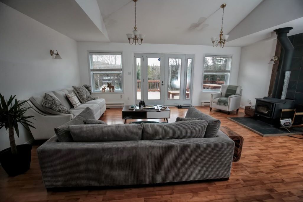 A spacious living room with a sofa, a coffee table, and a fireplace.