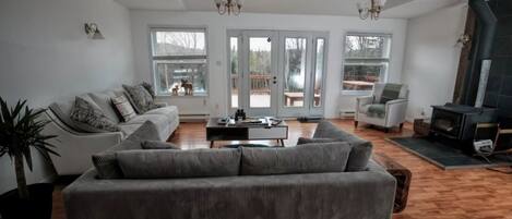 A spacious living room with a sofa, a coffee table, and a fireplace.