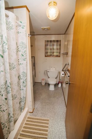 Shower, hair dryer, soap, toilet paper