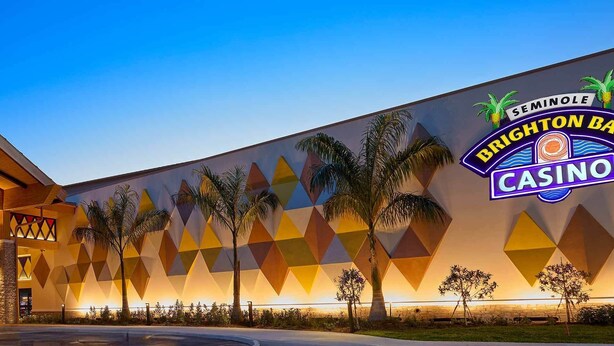 A casino building with a geometric facade and a covered entrance area. - Seminole Brighton Bay Hotel & Casino (Okeechobee)
