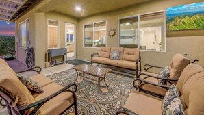 A covered patio area with a sofa, chairs, and a coffee table. - Secluded Private Golf/Pool Home With Game Room (Indio)