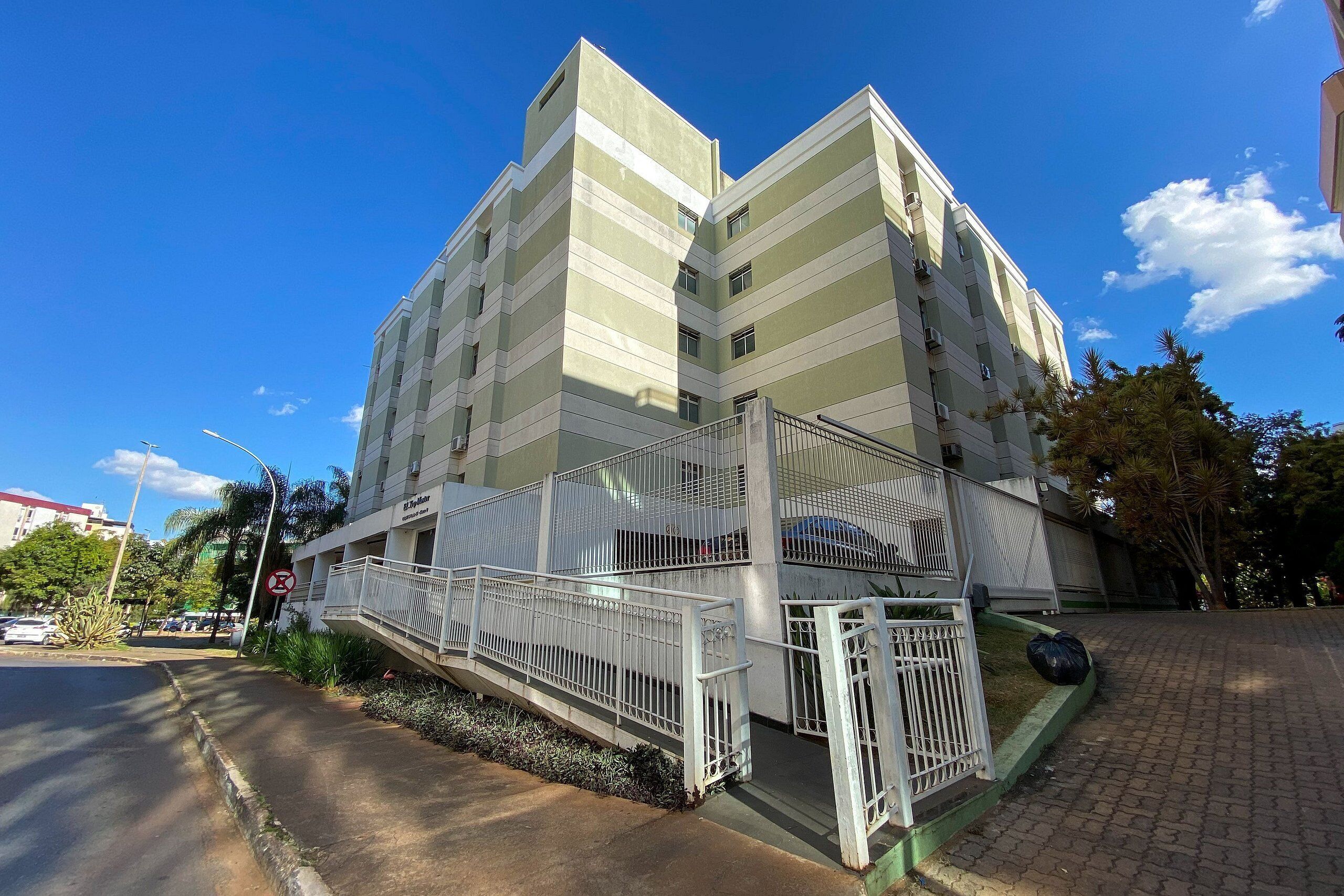 A multi-story building with a staircase leading to a balcony.