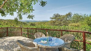 A round wicker table with four chairs on a stone patio, overlooking a lush green landscape with distant hills. - Lovingly Restored Country Villa, A/C, Private Pool (Fenced), Idyllic Views - 15mins drive to Tavira (Santa Catarina da Fonte do Bispo)
