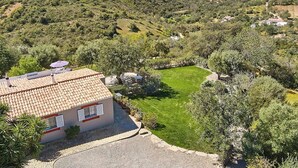 A villa with a tiled roof, a well-maintained lawn, and a view of the surrounding countryside. - Lovingly Restored Country Villa, A/C, Private Pool (Fenced), Idyllic Views - 15mins drive to Tavira (Santa Catarina da Fonte do Bispo)
