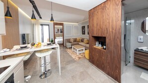 A modern kitchen with a dining area, wooden accents, and a built-in oven.