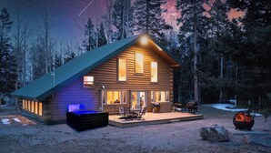 A log cabin with a deck, outdoor seating, and a fire pit.