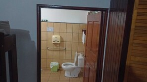 A small bathroom with a toilet, a hand dryer, and a trash bin. - Thermomania (Fortuna)
