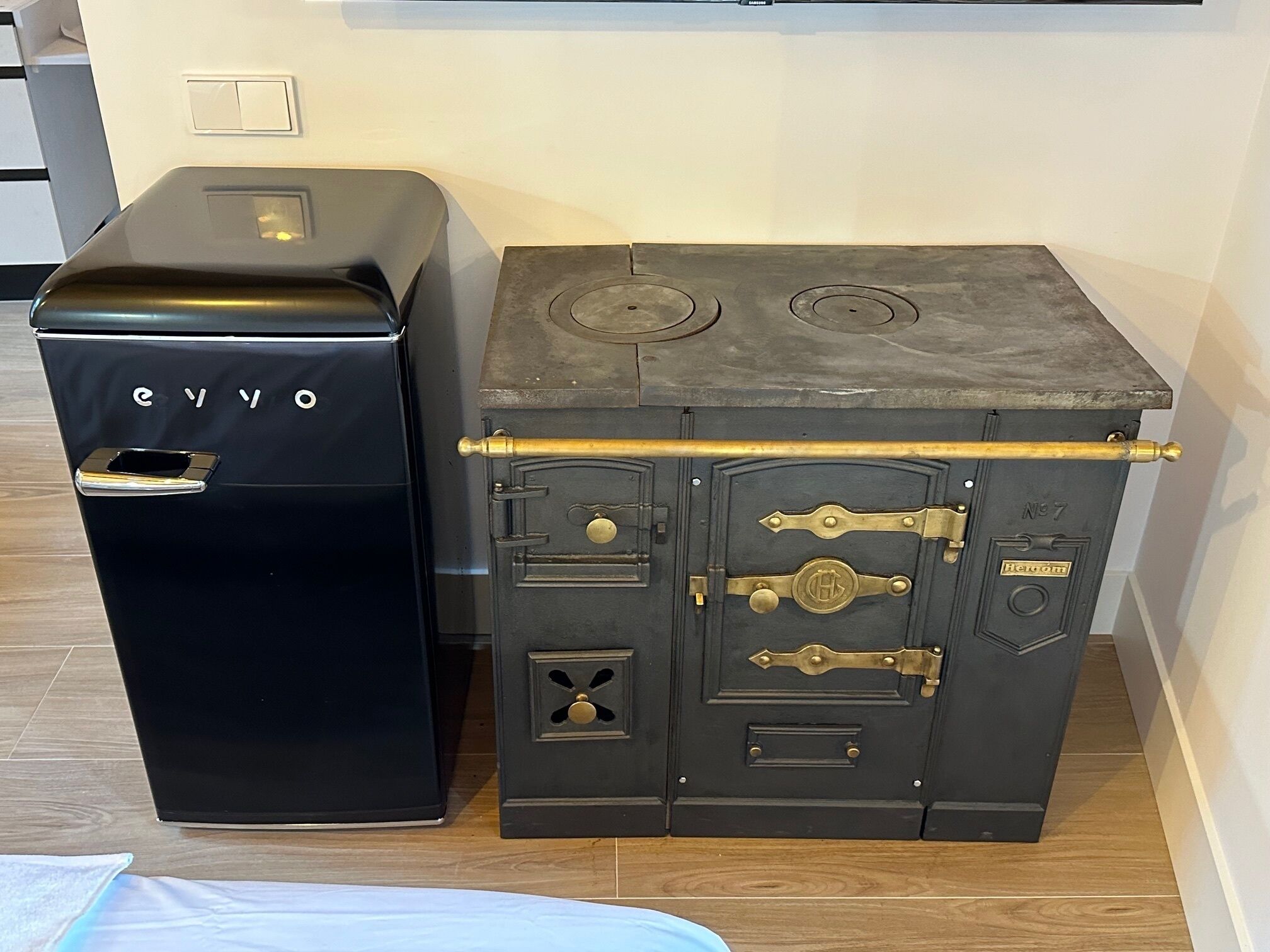 A black and grey safe with a brass handle and lock, and a smaller black safe with a silver handle.