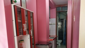 A compact kitchen with a refrigerator, a sink, and a stove.