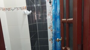 A bathroom with a toilet, bidet, and shower area.