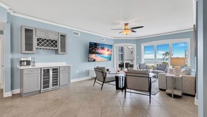 A spacious living area with a kitchen, dining table, and seating. - 3402 Windsor @ Palmetto Dunes | Oceanfront | Steps to Beach | Pool | Stunning Views (Hilton Head Island)