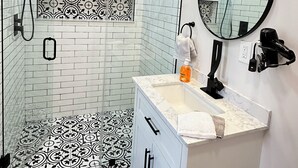 A bathroom with a shower, a vanity with a mirror, and a toilet. - GETAWAY/PRIVATE SUITE C, (Lutz)