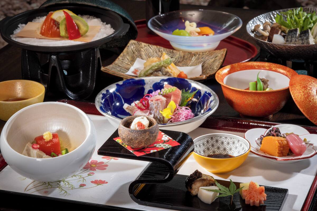 A variety of dishes on a tray, including sushi and other Asian cuisine.