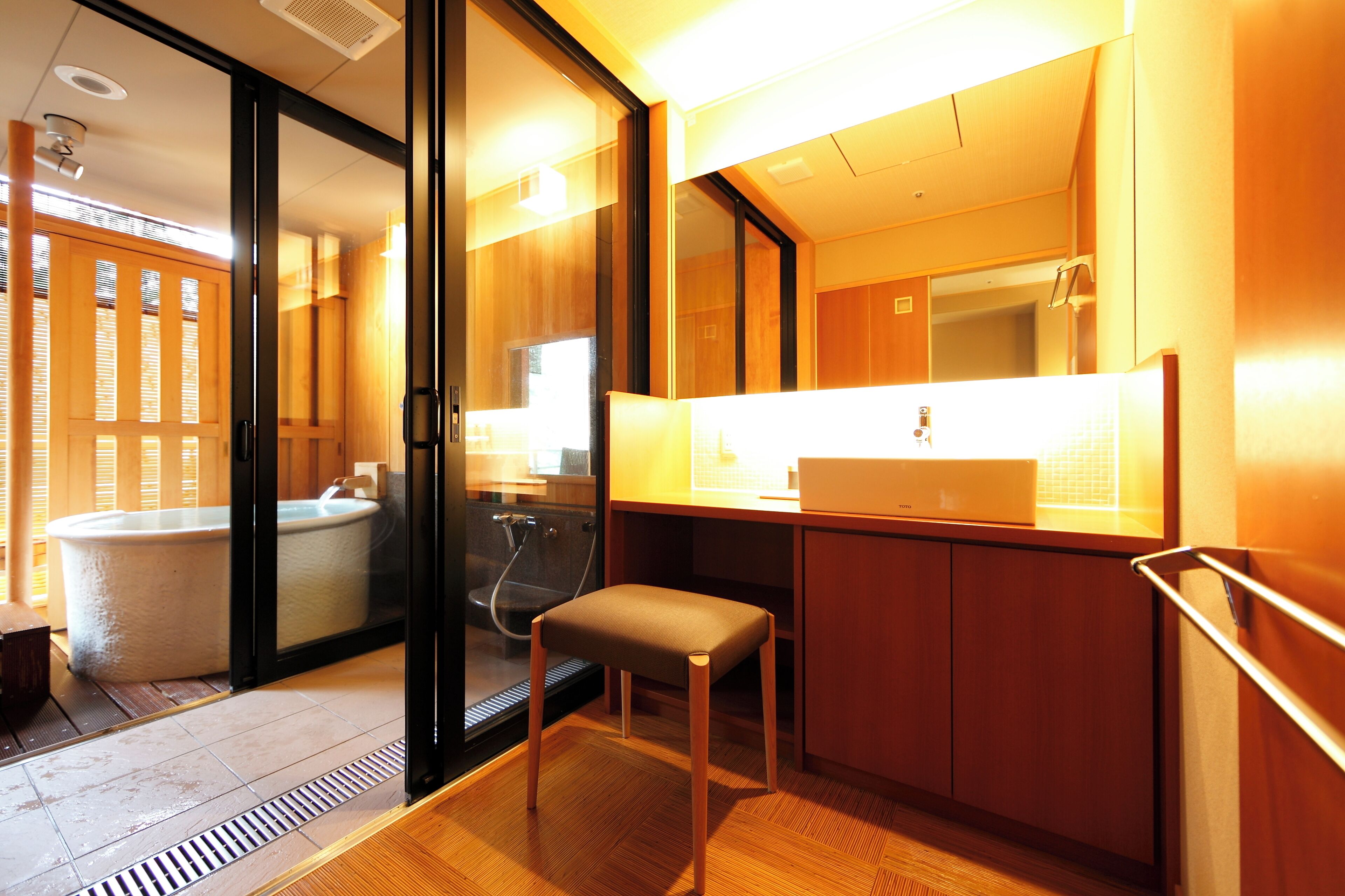 A modern bathroom with a bathtub, a sink, and a mirror.