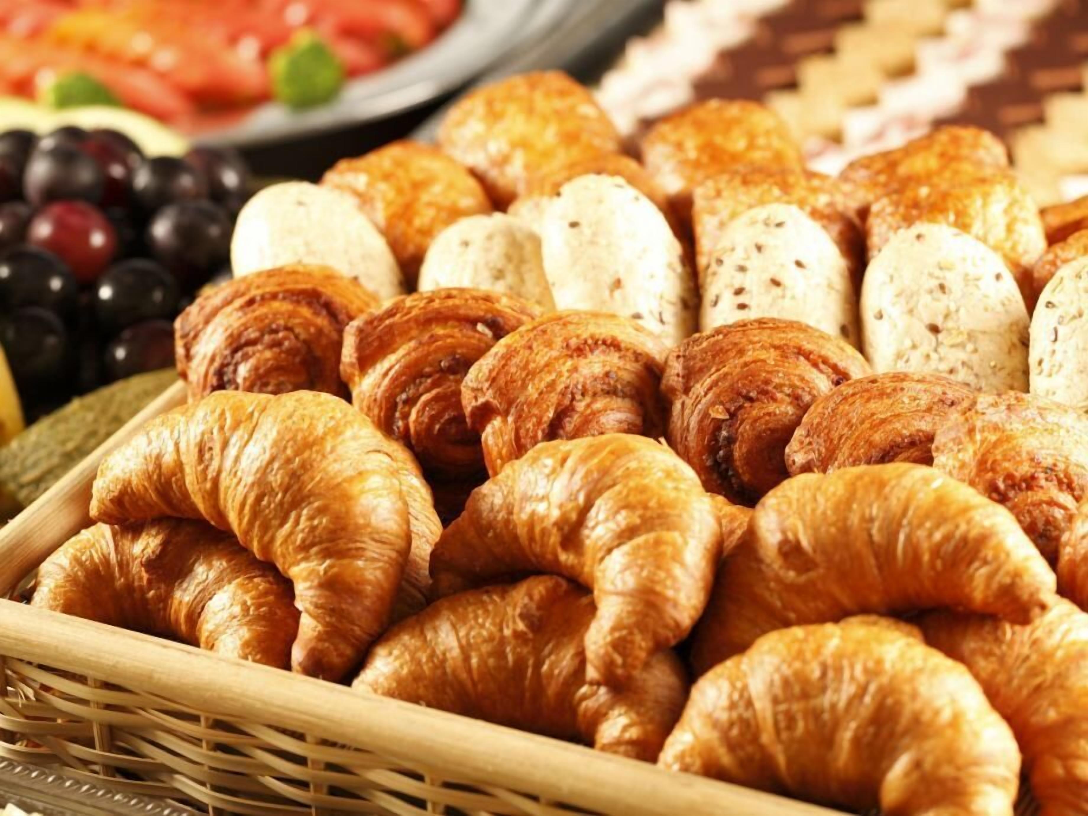 A variety of baked goods including croissants and bread rolls.