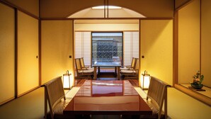 A traditional Japanese room with tatami flooring, a low table, and shoji screens. - Hotel Nanpuso (Hakone)