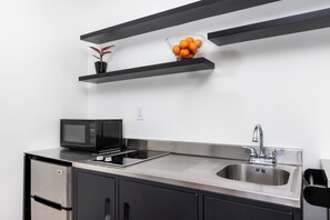 Premium bedding, desk, laptop workspace, blackout drapes -  The Nirvana Apartment Hotel (Los Angeles)