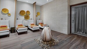 Relax in a serene space with three massage chairs, a unique sculpture, and a peaceful view.