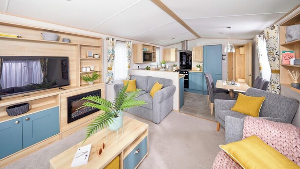 A compact RV interior with a living area, kitchenette, and dining space. - Platinum 3 No Pet Sleeps 6 (Penhallow)
