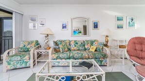 A living room with a sofa set, a coffee table, and two lamps. - About the View at Ocean House 312 (St. Augustine)