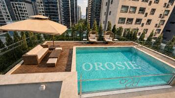 A rooftop pool with the name 'OROSIE' and a number '28' on the edge.