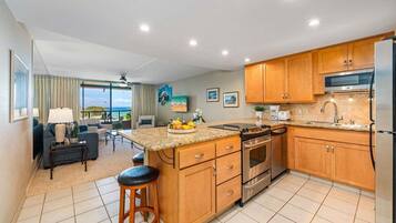 A modern kitchen with wooden cabinets, stainless steel appliances, and a large island.