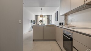 A modern kitchen with a central island, built-in oven, and stainless steel appliances. - Cosy Beach | Beach - pool - terrace (Marbella)