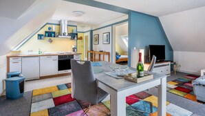 A modern loft apartment with a kitchen, dining area, and a bedroom. - Apartment 'Bi Buje' with Balcony and Wi-Fi (Nordstrand)