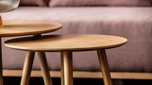 Two round wooden tables with metal legs, placed on a dark floor. - Design Apartment Au with Mountain View, Balcony and Wi-Fi (Au)