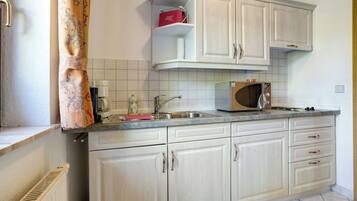 Fridge, microwave, stovetop, coffee/tea maker