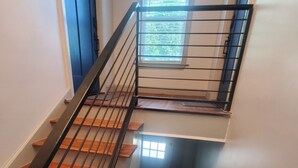 A staircase with wooden steps and black metal railings.