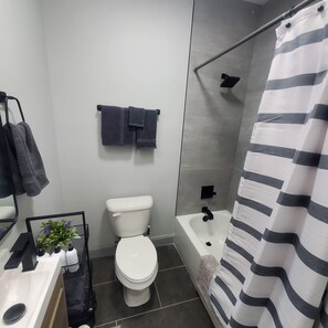 A modern bathroom with a toilet, sink, and shower. - 2-bedroom condo just 8 minutes from University of Alabama-Birmingham (Birmingham)