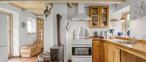 Een koelkast, een oven, een kinderstoel, kookgerei, borden en bestek