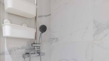 Shower, hair dryer, towels, shampoo