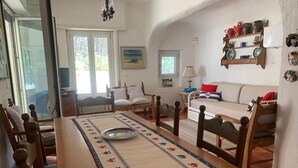 A cozy dining area with a wooden table, chairs, and a patterned table runner. - Splendid detached villa, near the sea (Santa Lucia)