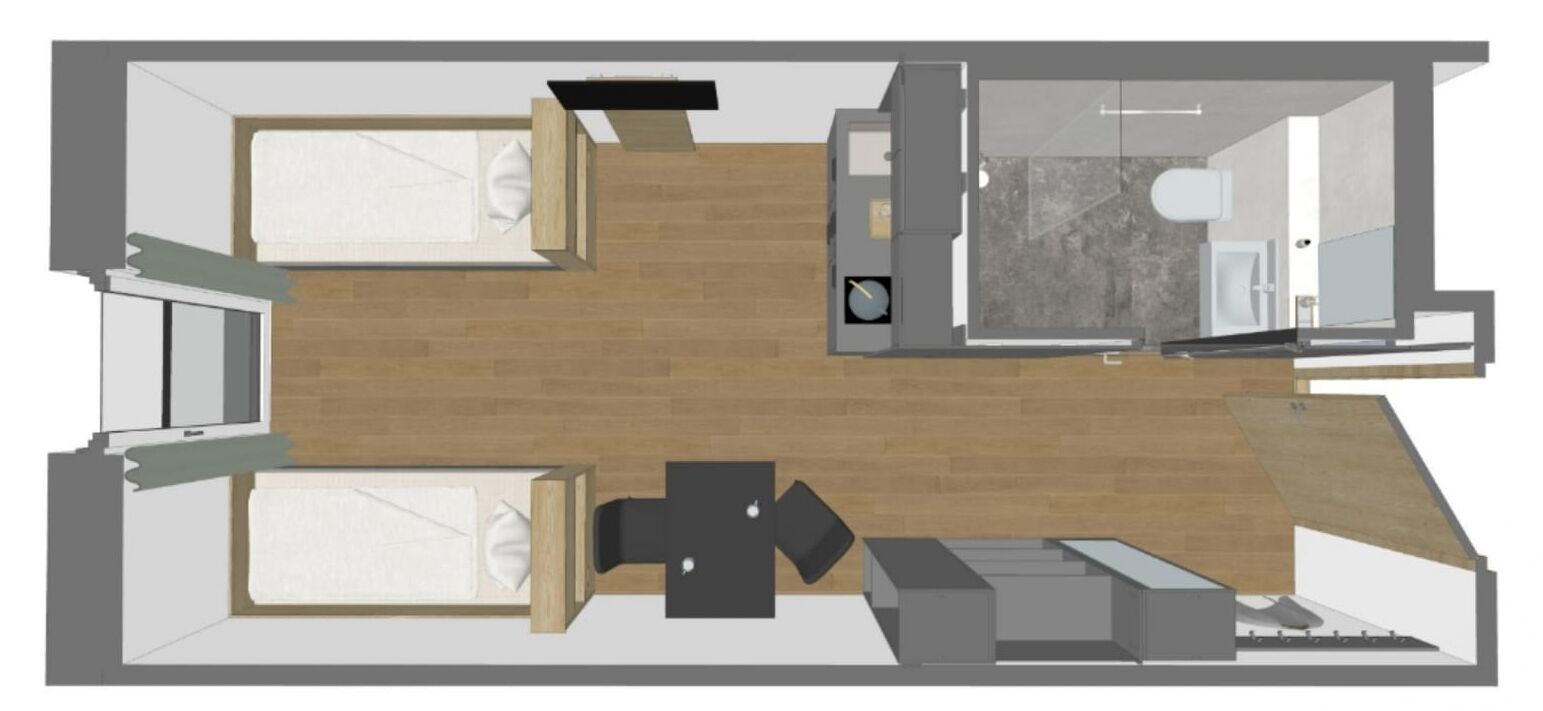 Un plan d’étage d’une chambre d’hôtel comprenant un lit, un bureau, une chaise, une petite table et une salle de bain.