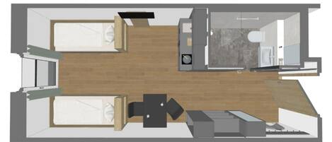 A floor plan of a hotel room with a bed, a desk, a chair, a small table, and a bathroom.